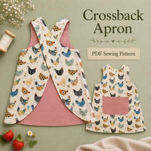 May include: A crossback apron PDF sewing pattern featuring a cream-colored fabric with a multi-colored chicken and floral print, lined with solid dusty pink fabric. The apron has wide shoulder straps and a solid dusty pink rectangular front pocket.