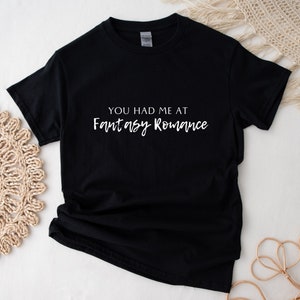 May include: Black t-shirt with white text that reads "You had me at Fantasy Romance."