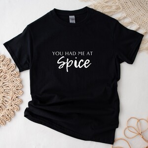 May include: Black t-shirt with white text that reads "You had me at Spice".