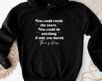 May include: Black hoodie with a white quote that reads "You could rattle the stars. You could do anything, if only you dared. Throne of Glass".