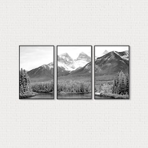 Könnte beinhalten: Ein Triptychon gerahmter Schwarz-Weiß-Landschaftskunst. Jeder Rahmen zeigt eine Berglandschaft mit schneebedeckten Gipfeln, einem Fluss und immergrünen Bäumen. Das Kunstwerk wird vor einer weißen Backsteinmauer ausgestellt.