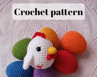 May include: Crochet pattern for a white chick surrounded by six colorful crocheted eggs. The eggs are green, orange, red, purple, blue, and yellow.