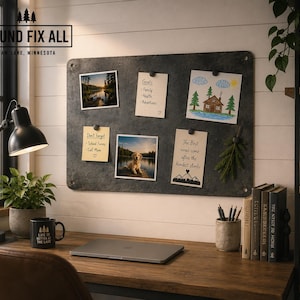 May include: A rectangular dark grey metal magnetic memo board mounted on a white wall, featuring rounded corners and four corner holes. The board displays various pinned items including photographs, a goals list, a drawing, and handwritten notes.