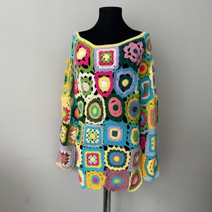 May include: A colorful crochet top with a patchwork design featuring squares and circles in various shades of pink, green, blue, yellow, and purple.