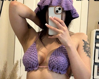 May include: A purple and pink crocheted bikini top and bottom with a ruffled trim. The bikini top is a triangle style and the bottom is a high-cut style with ties on the sides.
