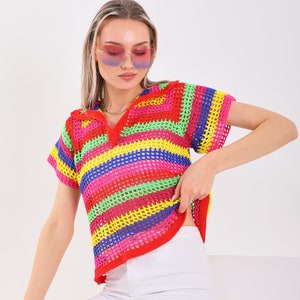 May include: A rainbow striped crochet top with a v-neck and short sleeves. The top is made of a lightweight, open-weave fabric.
