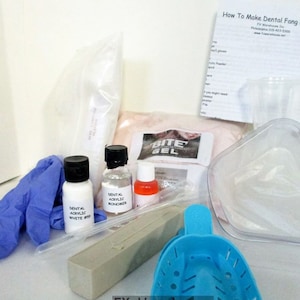 May include: A kit for making dental fang caps, including acrylic powder, monomer, a mixing cup, a bite registration tray, gloves, and instructions. The kit includes the text "How To Make Dental Fang Caps".
