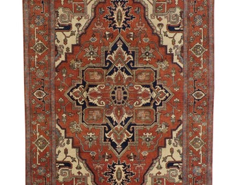 May include: A traditional Persian rug with a red, cream, and blue color scheme. The rug features a central medallion with intricate floral and geometric patterns. The rug has a fringed border.