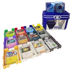 May include: A blue and white card storage unit with the word "Mart" on the front, and several coloured card holders. The card holders are filled with various trading cards. The top of the unit holds more cards.