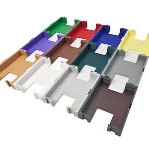 May include: An assortment of colorful, rectangular plastic trays. The trays are in various colors, including green, red, purple, brown, teal, blue, yellow, gray, white, and tan. Each tray has a rectangular interior and a cutout on one side.