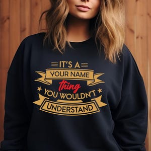 May include: Black sweatshirt with a gold and red graphic that says "It's a [Your Name] thing you wouldn't understand."