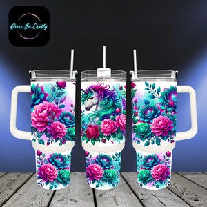 May include: Three white stainless steel tumblers with lids and handles. The tumblers feature a unicorn with a pink and blue mane and tail, surrounded by pink and blue flowers on a white background.