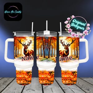 May include: Three insulated tumblers with white handles and straws. Each tumbler features a deer in a forest scene with autumn colors. The word "Name" is printed on each tumbler. The Dixie Be Crafty and Original Designer logos are also visible.