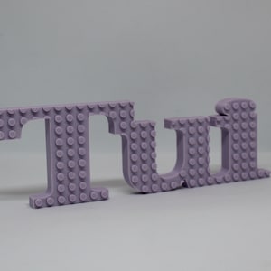 Tui name in large Brick format, compatible with all brands of brick games, ideal for decorating your room or wall.