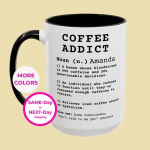 May include: White ceramic coffee mug with a black interior and handle. The mug features the text "COFFEE ADDICT" and a definition. A pink circle with "MORE COLORS" and another with "SAME-Day or NEXT-Day shipping" are also visible.