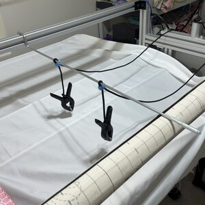 After releasing the clamps, it secures them and prevents them from falling to the floor.