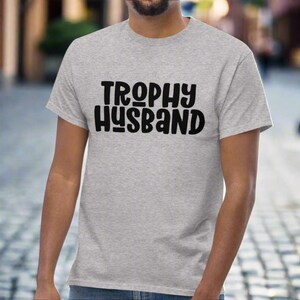 Trophy Husband T-Shirt – Funny Tee for Husbands, Anniversary, Bachelor Party, or Valentine’s Day, Gag Gift for Husbands
