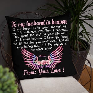 May include: Black cushion featuring a touching message, angel wings, and floral details. The text says "To my husband in heaven" with a loving message and "From: Your Love!"