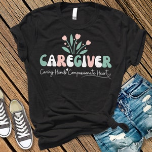 Caregiver Shirt | Thank You Gift | Gift For Caregiver | Caregiver Tee | Caring Hands, Compassionate Heart Unisex t-shirt