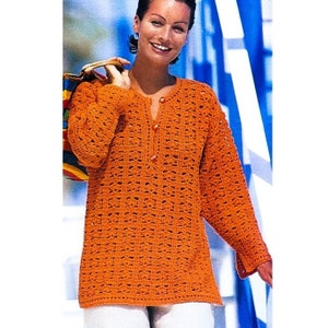 May include: A crocheted orange top with a V-neck and button closure. The top has a loose fit and long sleeves.
