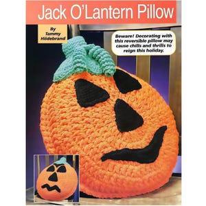 May include: An orange Jack O'Lantern pillow with black eyes, nose, and mouth, and a green leaf. The text "Jack O'Lantern Pillow" is at the top. The pillow is reversible and may cause chills and thrills this holiday.