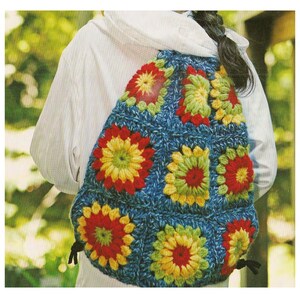 May include: A blue crocheted backpack with colourful flower-shaped motifs. The backpack has a drawstring closure and is made with a variety of yarn colours, including red, yellow, green, and blue.