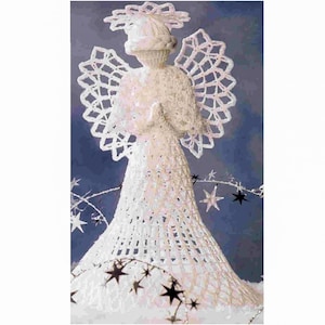 May include: White crocheted angel ornament with a halo and wings. The angel is standing on a bed of white fabric with black star-shaped decorations.