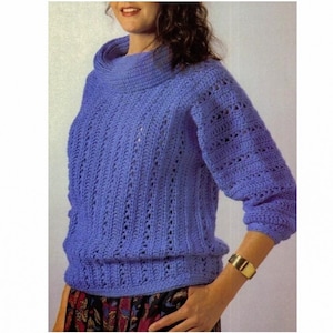 May include: A purple crocheted sweater with a turtleneck and long sleeves. The sweater has a lacy pattern.