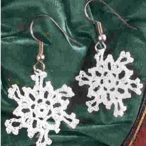 May include: A pair of white crocheted snowflake earrings with silver hooks.
