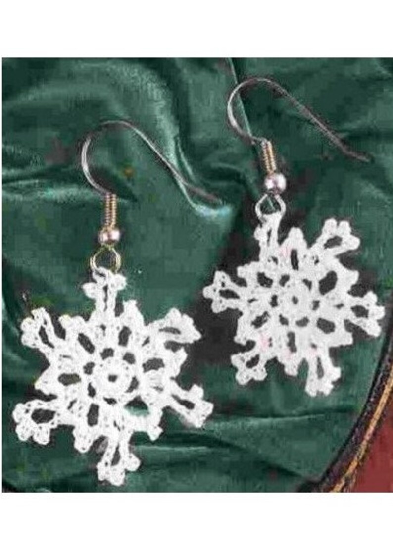 May include: A pair of white crocheted snowflake earrings with silver hooks.