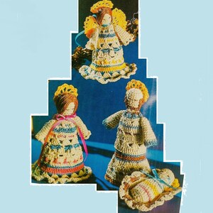 May include: Crocheted Christmas ornaments featuring a nativity scene with a baby Jesus, Mary, Joseph, and an angel. The ornaments are made with white, yellow, blue, pink, and brown yarn.