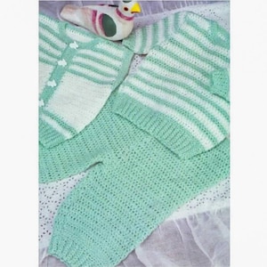 May include: A crocheted baby outfit in green and white. The outfit includes a striped sweater and pants.