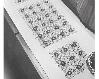 May include: Two crocheted table runners with a floral design. The runners are white with a dark brown center in each flower.