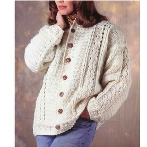 May include: A white crocheted cardigan with a button-up front and cable knit detail.