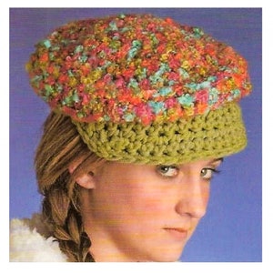 May include: A colorful crocheted hat with a green crocheted brim. The hat is made with a variety of colors, including pink, blue, green, and yellow.