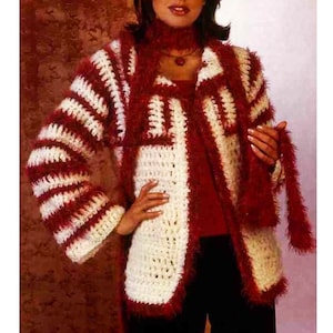 Peut inclure: Un cardigan en crochet blanc et rouge avec une texture duveteuse. Le cardigan a un col châle et des manches longues.