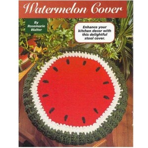 May include: A round, watermelon-themed stool cover. The cover features a red center with black seed accents, a white rind, and a green crocheted edge. Text on the cover reads "Watermelon Cover" and "Enhance your kitchen decor with this delightful stool cover."