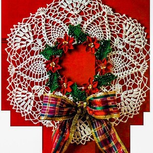 May include: White crocheted doily with a red and green poinsettia wreath and a plaid bow.