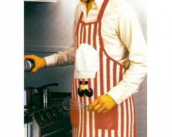 May include: A red and white striped crochet apron with a white chef's hat and a black mustache. The apron has a pocket on the front.