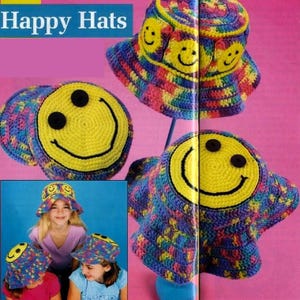 May include: Crocheted bucket hats with a yellow smiley face design. The hats are multicolored with blue, pink, yellow, and green yarn. The text "Happy Hats" is at the top of the image.