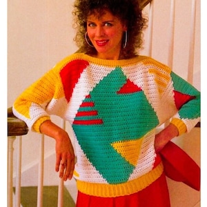 May include: A crocheted sweater with a geometric pattern in white, yellow, red, and green.