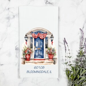 May include: A watercolor illustration of a blue front door with a red, white, and blue bunting above it. The door has a red welcome mat and is flanked by two potted plants. The address "60108 BLOOMINDALE, IL" is printed below the door.
