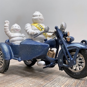 Michelin man riding motorbike with sidecar - Michelin mascot &#39;Bibendum&#39;