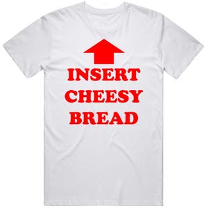 May include: White t-shirt with the text "INSERT CHEESY BREAD" in red, with a red arrow pointing upwards. The shirt is a casual, crew neck style.