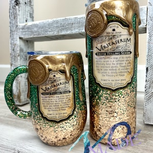 May include: Two gold and green glitter tumblers with a gold wax seal and a label that reads "Brewed by Severus Snape Veritaserum Truth Telling Serum Very powerful! Three drops of this colorless, odorless serum is a sufficient dose to effectively force the drinker to speak their innermost secrets. Though there may be some methods of resistance, this potion is strictly controlled by the Ministry of Magic. Brewed for one lunar phase."