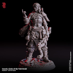 May include: A detailed miniature figurine of a male elf druid, painted in a grey color scheme. He is wearing a leather and fur outfit, holding a staff and a pouch. The figurine is standing on a circular base.