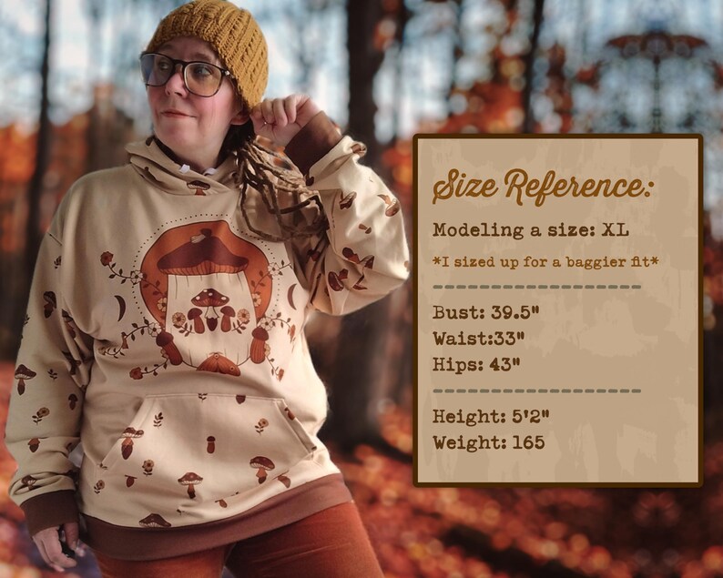 May include: A beige hoodie with a mushroom graphic and the text "Shroom Queens". The model is wearing a size XL and is 5'2" tall and weighs 165 pounds.