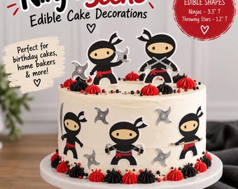 May include: A round cake decorated with edible ninja-themed shapes, including cartoon ninjas in black outfits with red belts and gray throwing stars. The cake features white frosting, red and black piped icing borders, and small metallic sprinkles.