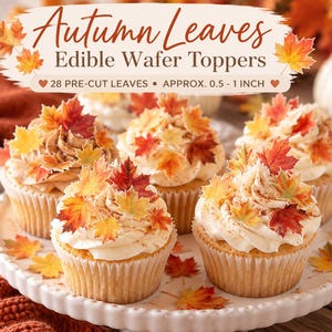 May include: A set of 28 pre-cut edible wafer toppers shaped like autumn leaves, ranging from 0.5 to 1 inch in size. The toppers feature red, orange, and yellow colors and are displayed on frosted cupcakes with text reading Autumn Leaves Edible Wafer Toppers.