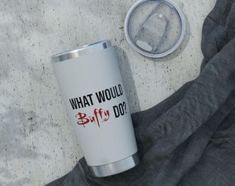 May include: A white stainless steel tumbler with a silver rim and base, featuring the black text "WHAT WOULD" and the red text "Buffy DO?" with a blood-drip effect on the word Buffy. The tumbler includes a clear, circular plastic lid.